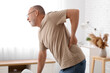 © Pixel-Shot - Mature man suffering from back pain at home