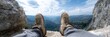© olga_demina - Hiker is taking a break on the edge of a cliff, enjoying the breathtaking panorama of a valley below, showcasing the beauty of nature and the spirit of adventure