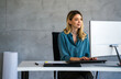 © NDABCREATIVITY - Young happy successful business woman working with computer in corporate office