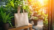 © Rika - Beige canvas tote bag displayed amidst greenery.