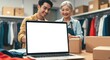 © UrFreepik360 - Photo of Asian business partners packing boxes while using a laptop in their clothing store