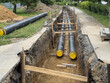 © Martin Mecnarowski - Underground installation of preinsulated district heating pipes in urban environment. Ideal for: energy infrastructure, sustainable heating systems, and civil engineering documentation.