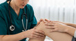 © Inspire Shots Hub - Close-up of doctor's hands examining patient's knee, showcasing medical examination and healthcare concept