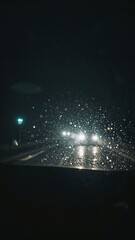 Wall Mural - blurry headlights cut through sleet during night highway drive