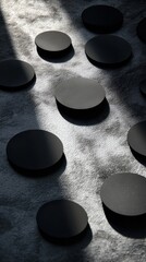 Wall Mural - artistic arrangement of matte black discs spread across a textured surface creating a visually strik