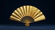 © Ganang - Ornate gold fan with floral design.