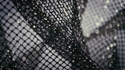 Abstract shot of dark woven net with blurry background texture