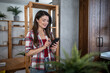 © Migma_Agency - Smiling freelancer using smartphone at home office