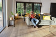 © Wavebreak Media - Senior African American man calling on smartphone sitting on sofa in living room, copy space