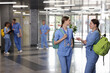 © New Africa - Medical students in uniforms indoors, selective focus