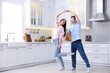© New Africa - Happy young couple dancing together in kitchen