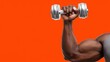 © OleksandrZastrozhnov - African male adult lifting dumbbell on vibrant orange background