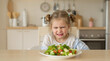 © Vera - A five year old girl sits at the table and does not want to eat vegetables, she is angry