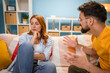 © Miljan Živković - Caucasian stressed couple sitting on couch, arguing at home.