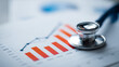 © kaliel - A Strategic Healthcare Finance Analysis Concept Displayed by a Stethoscope Resting on Rising Bar Charts to Indicate Medical Growth Metrics.