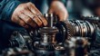© Attasit - Close-up of a mechanic repairing the transmission in a tractor, with an emphasis on the intricate mechanical components.