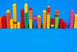 © Lalita - Colorful plastic building blocks forming bar graphs on a blue background, blue background, plastic
