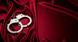 © Poetra RH - A pair of silver metal handcuffs rest on smooth red satin fabric, symbolizing themes of intimacy, sensuality, and fantasy. The image evokes a bold and provocative atmosphere.