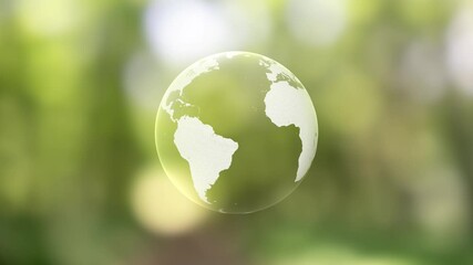 Wall Mural - concept digital earth globe planet loop rotation on sunny green blurred nature bokeh background.