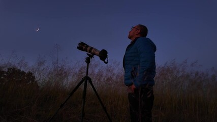 Wall Mural - amateur astronomer using camera and lens for photographing stars, moon, planets and other celestial 
