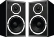 © Jolly - Two black speakers with white accents stand side by side on a white surface