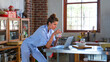 © Monkey Business - Side View Of Mid Adult Woman Using Laptop In Open Plan Apartment Kitchen