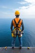 © Sangsung - Worker on Edge of High Platform Overlooking Calm Ocean Horizon