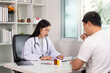 © Natee Meepian - Healthcare. Doctor consulting patient about treatment plan.