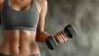 © Georg - Woman lifting dumbbell in workout attire during indoor exercise session at gym
