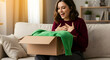 © Sulfabndi - Woman Excitedly Unboxing a Package Surprise Gift Delivery Happy Customer