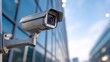 © intha - Smart security camera mounted on modern building exterior, clear sky