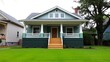 © MdJahid - Charming light blue bungalow style home with a welcoming front porch and manicured lawn