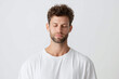 © Marut - Young man with curly hair and beard wearing white t shirt, eyes closed in peaceful mindfulness and calm expression, isolated on light background