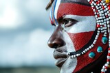 Close up profile of a Maasai warrior showcasing traditional face paint and beaded ornamentation