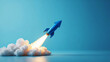 © DAYA-DAKSH - Blue rocket soars upward, symbolizing ambition, innovation and a rapid rise to success against a clean blue backdrop.