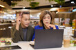 © Ranta Images - Gender diverse coworker business team eating salad and working digitally