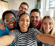 © Lumos sp - Group portrait of young happy businesspeople team taking a selfie photo in the office