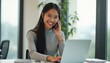 © natakot - Smiling woman on a phone call while working on a laptop