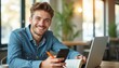 © natakot - Smiling young man studying with laptop and phone