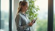 © natakot - Professional woman using a tablet in a modern office