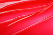 © New Africa - Texture of red lip gloss as background, top view