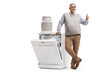 © Ljupco Smokovski - Smiling mature man leaning on a washing machine and showing thumbs up