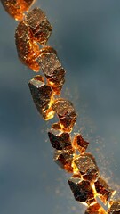 Wall Mural - glowing fragments of golden nuggets energetically burst, scattering shimmering particles across a re