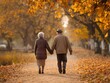 © MdMajnur - A senior couple walking hand in hand through autumn park