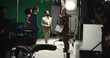 © peopleimages.com - Director, script and instruction to actor on set for creative guidance, cast direction and tips. People, filming team and producer with green screen for movie production, acting help and assistance