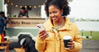 © Lahoud25/peopleimages.com - Happy, food truck and woman with phone and coffee on social media, internet and website on weekend. Customer review, outdoor and person on smartphone with drink by mobile cafe, restaurant and vendor