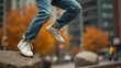 © ivanda - Lifestyle photograph showcasing white sneakers and blue jeans on an urban autumn day background