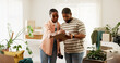 © peopleimages.com - Boxes, clipboard and moving house with black couple in living room for planning or relocation. Checklist, conversation and real estate with people in home for discussion, packing or property task