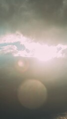 Wall Mural - Sunrays Sunray Shine Through Dark Clouds In Cloudy Blue Sky. Natural Background Time Lapse. Natural Sky Backdrop Weather Conditions. Cloudy Sky With Fluffy Clouds. Sunset Sky Natural Background