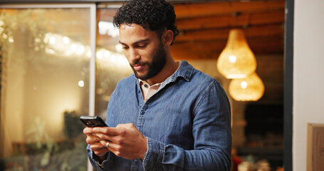 Phone, smile and man in coffee shop with networking, communication or connectivity in mobile app. Cellphone, texting and male person on blog for restaurant review on website in cafe or diner.